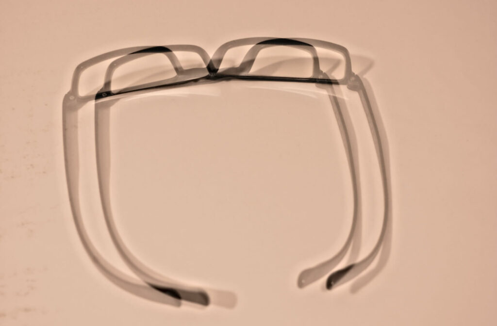 a pair of glasses appearing in double vision to simulate astigmatism.