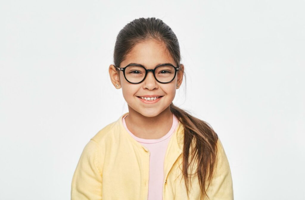 Little girl with myopia happily wearing glasses