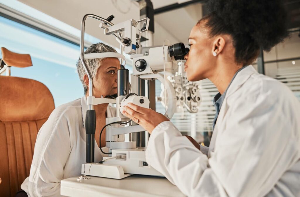 An optometrist evaluates their patient's ocular health with a slit lamp exam.