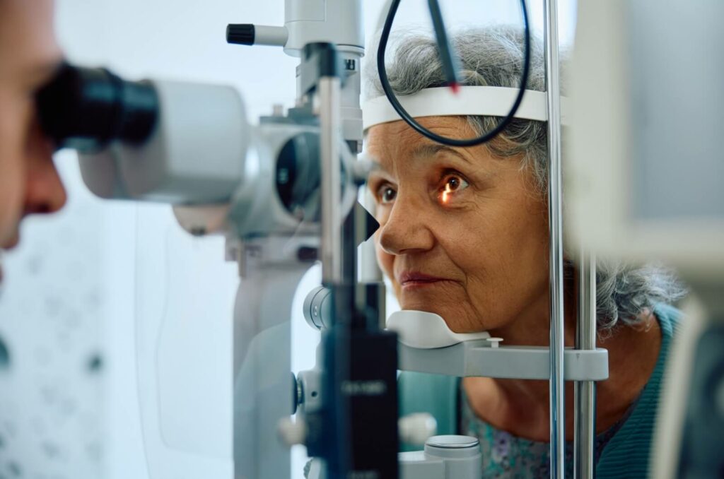 Elderly woman undergoing an eye examination for glaucoma diagnosis.