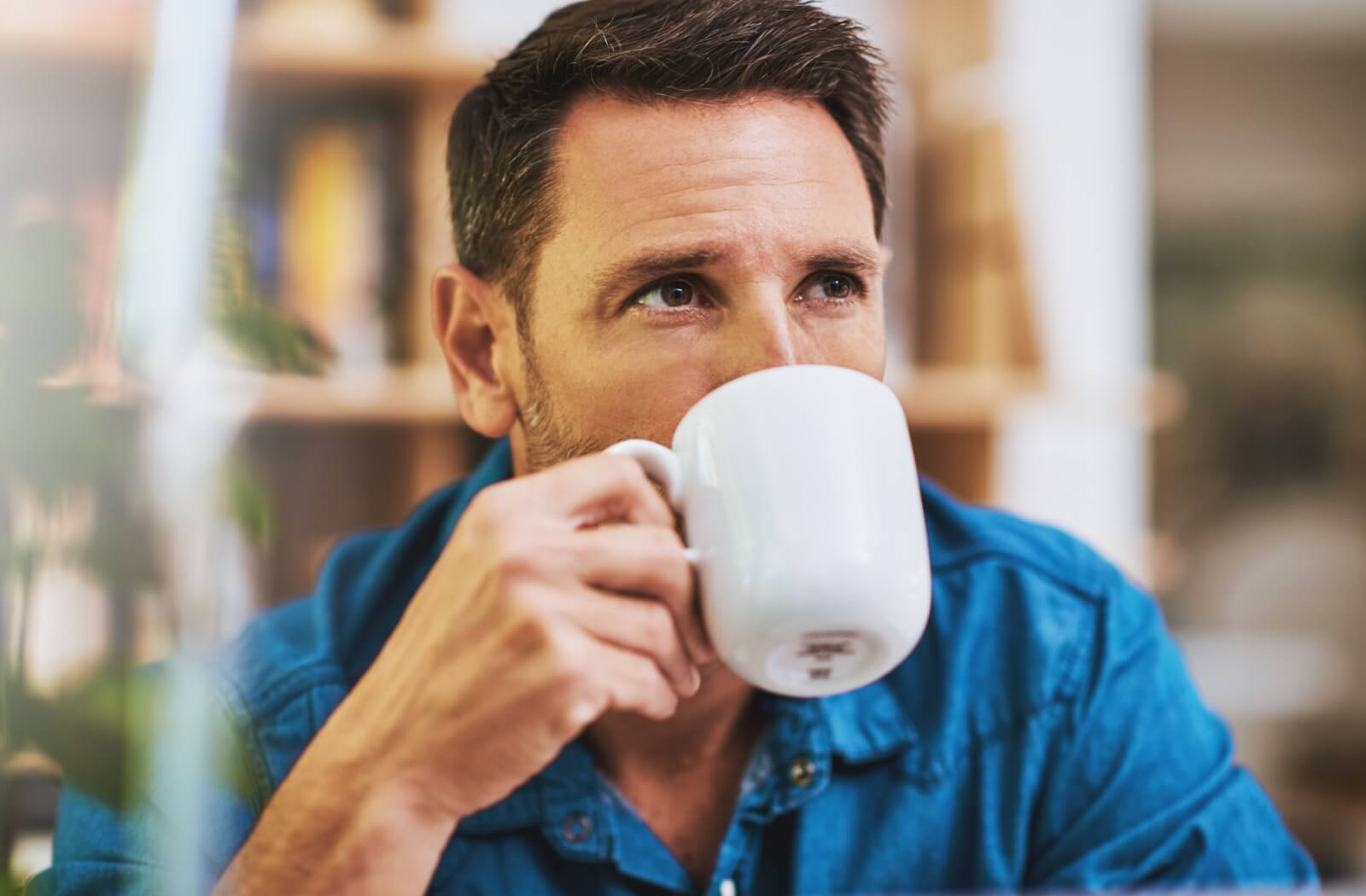 A man drinking coffee in a cozy setting