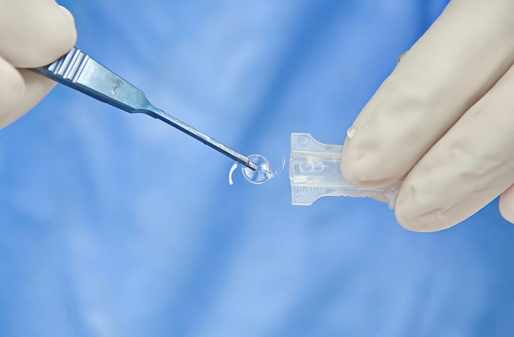 A close-up image of doctor getting an intraocular lens ready during cataract surgery.
