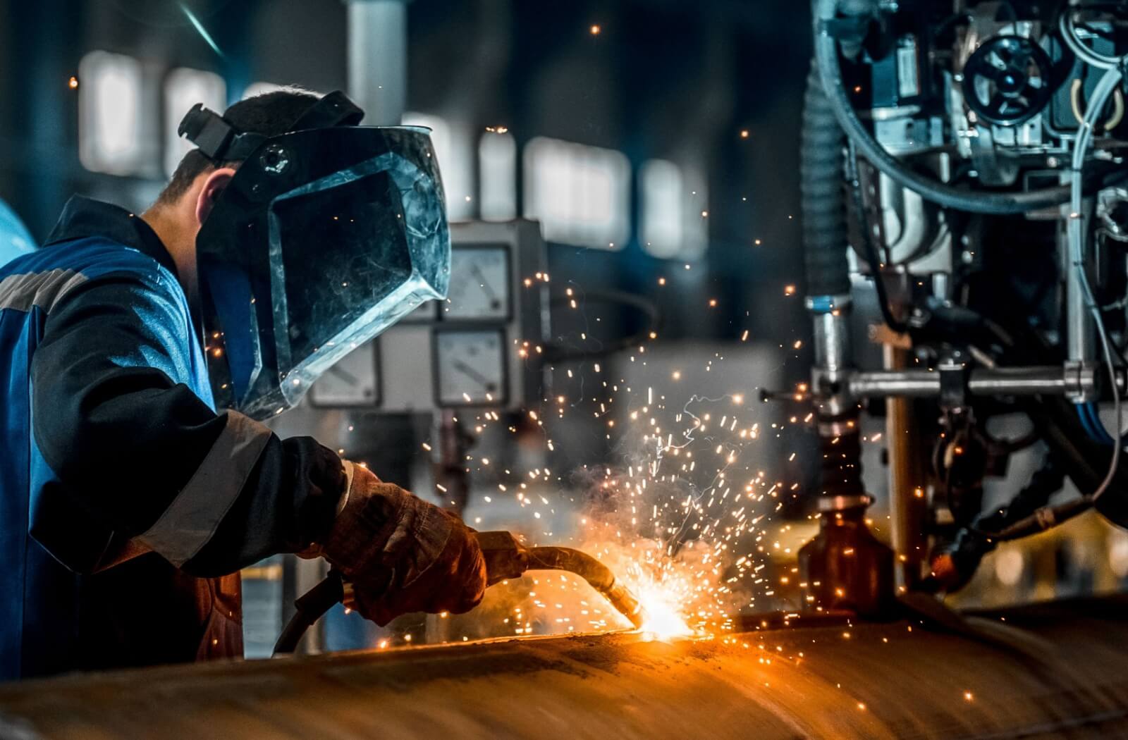 A welder wears a special UV protection mask to protect their eyes from radiation from the welding arc.