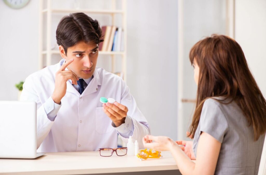 An optometrist goes over proper contact lens handling with a patient during their annual contact lens exam and fitting.